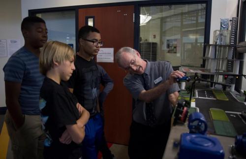 Dr. Godfrey showcasing robotics projects to junior high students